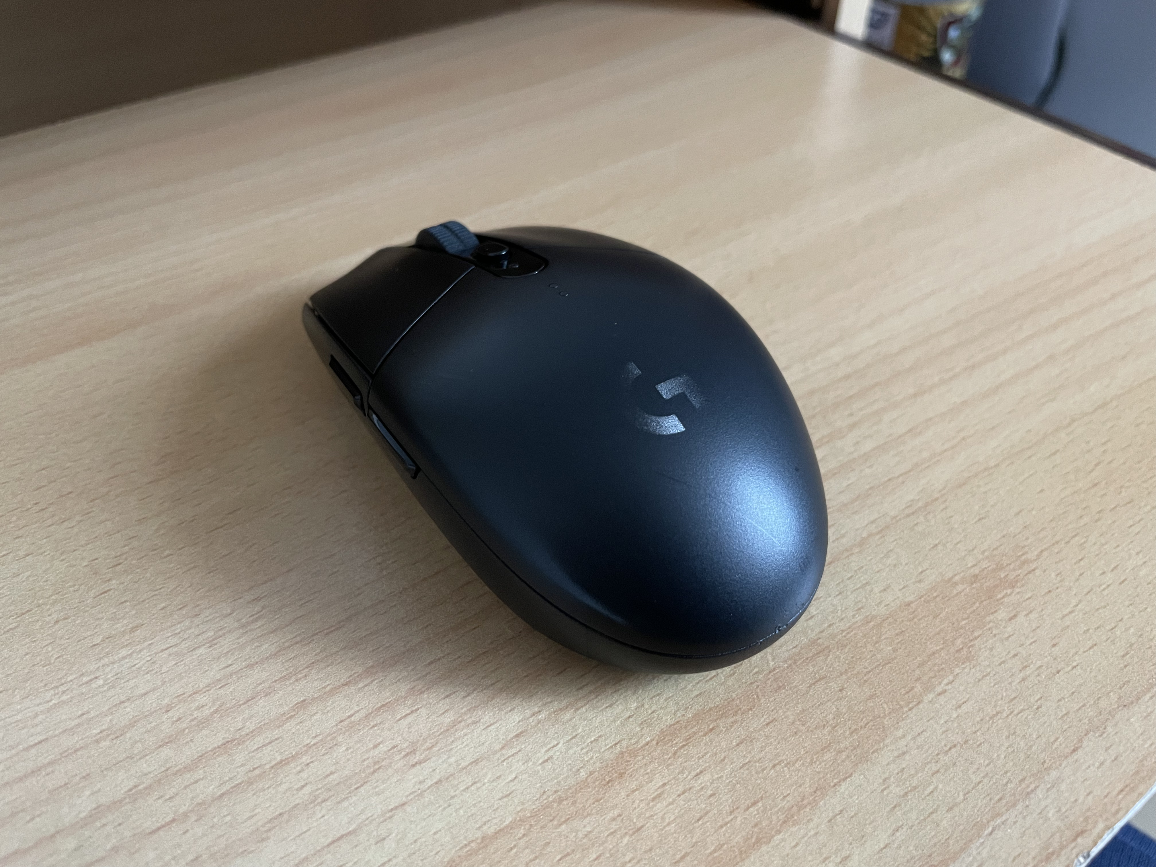 Black classic Logitech G305 mouse viewed from above and the left side