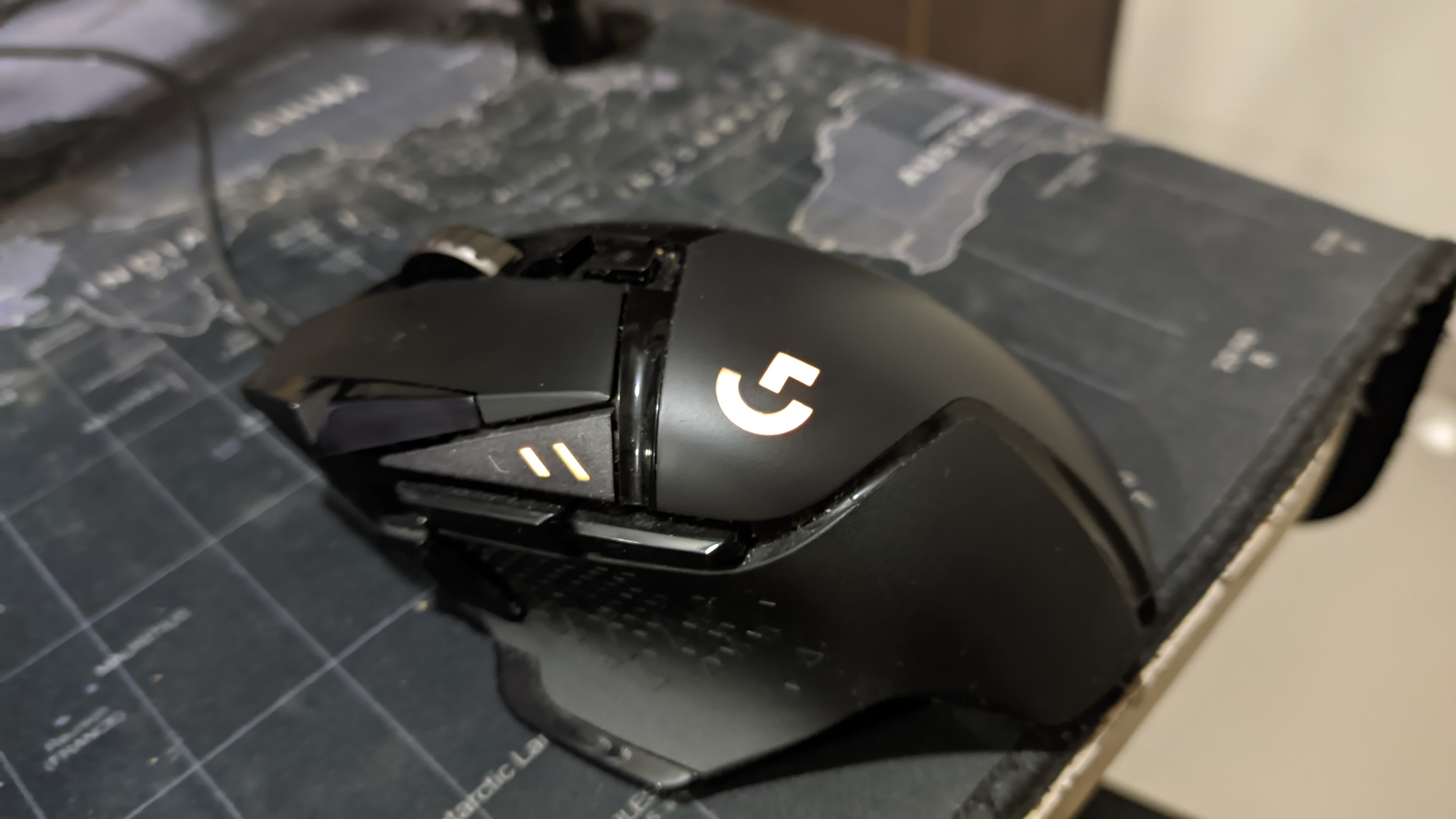 Black classic wired Logitech G502 HERO with orange RGB illumination
